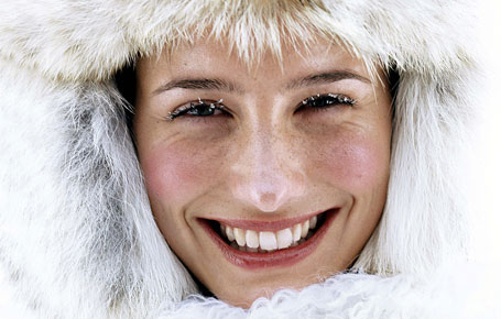 A woman using winter skin care tips to protect her face.