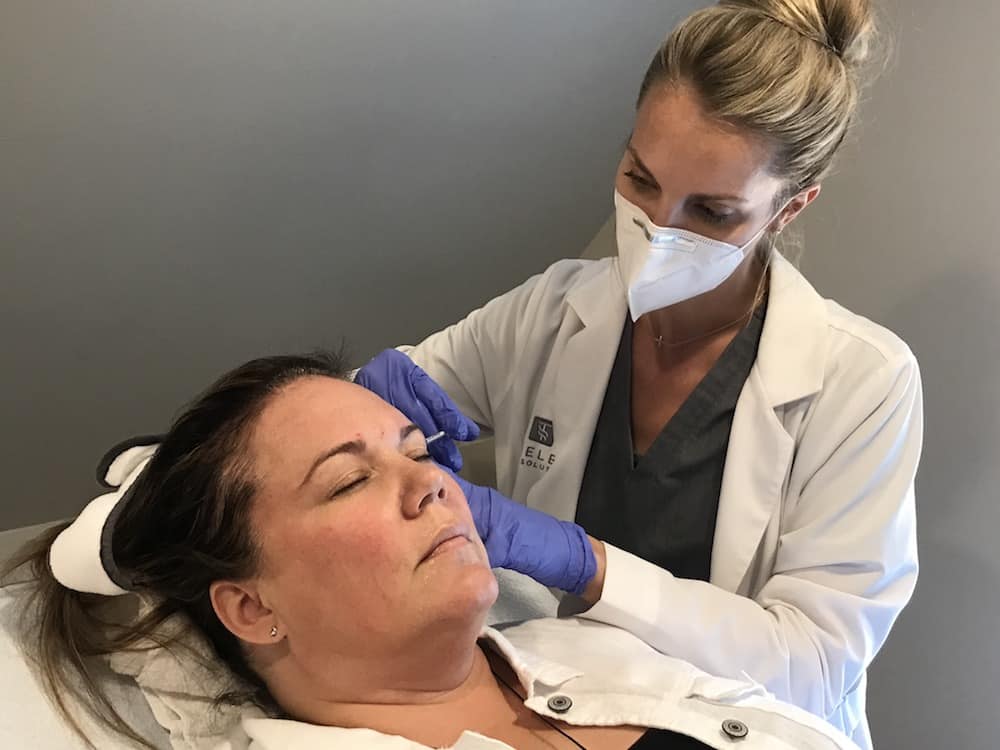 A woman getting Botox® treatment.